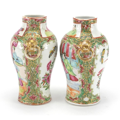 259 - Pair of Chinese Canton porcelain vases with elephant head ring handles, both hand painted in the fam... 