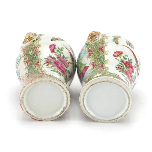 259 - Pair of Chinese Canton porcelain vases with elephant head ring handles, both hand painted in the fam... 