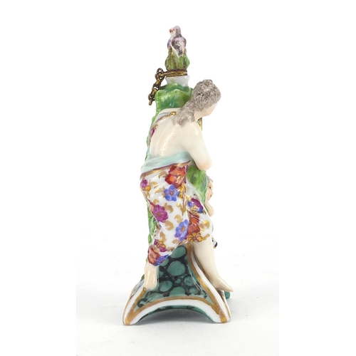 446 - Chelsea girl in the swing style porcelain scent bottle, modelled with a lady, dog, cherub and clock,... 