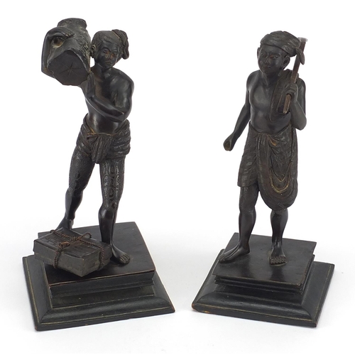 9 - Two Asian bronze studies of workmen, both raised on square wooden bases, the largest 20cm high