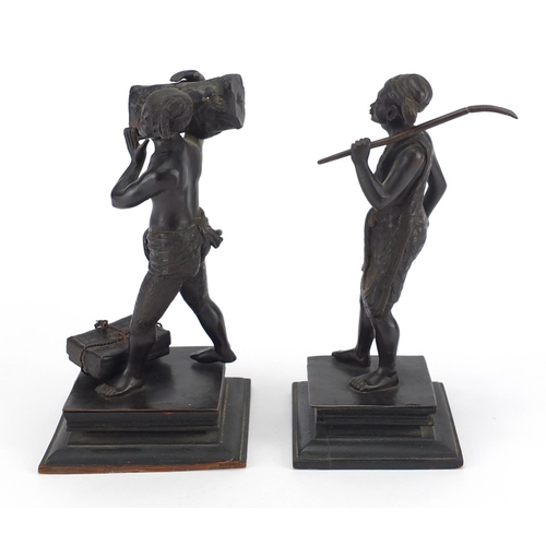9 - Two Asian bronze studies of workmen, both raised on square wooden bases, the largest 20cm high