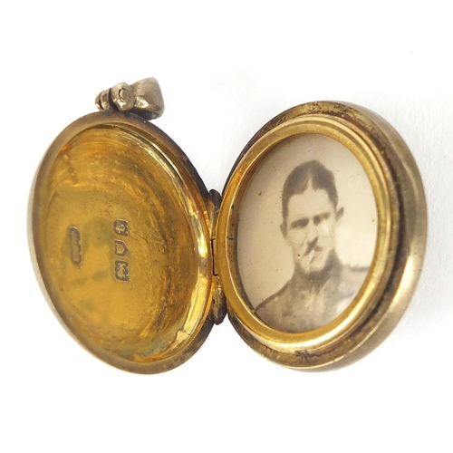 188 - Worcestershire Regiment silver locket together with a miniature 1914-18 war medal, cap badge and thr... 