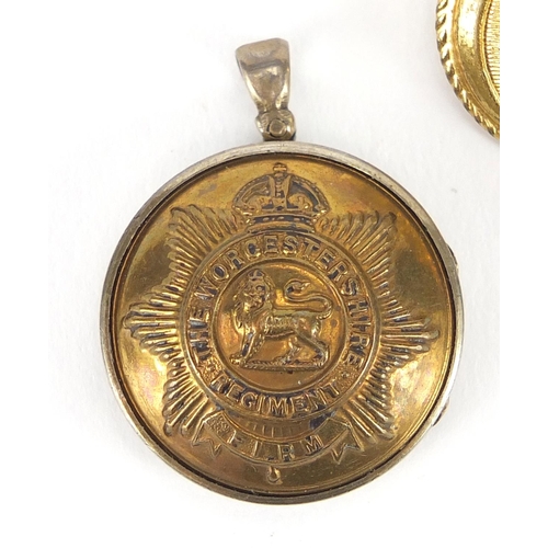 188 - Worcestershire Regiment silver locket together with a miniature 1914-18 war medal, cap badge and thr... 