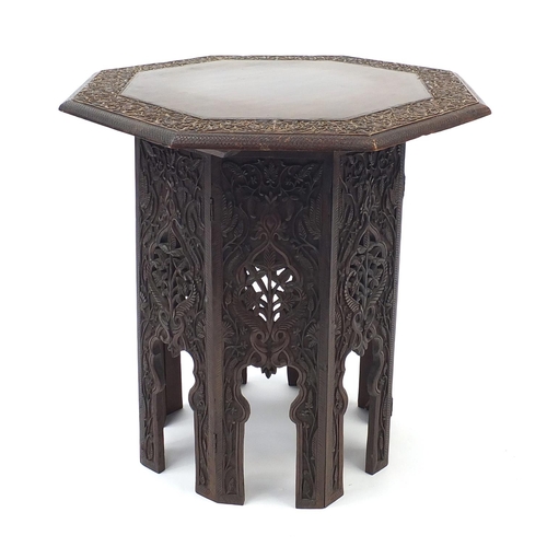 426 - Middle Eastern octagonal table profusely carved and pierced with foliage, 50cm high x 49cm in diamet... 
