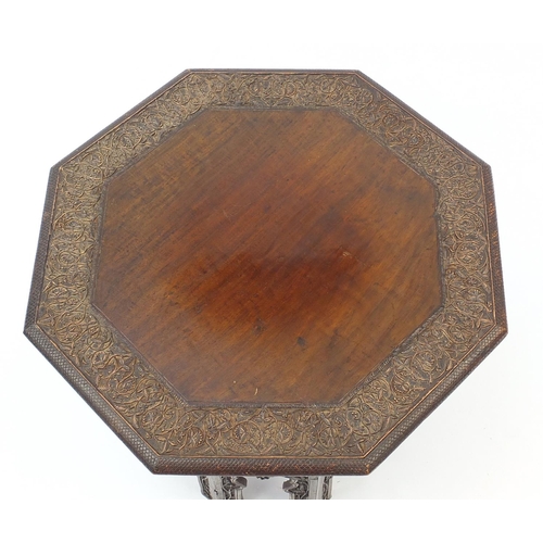 426 - Middle Eastern octagonal table profusely carved and pierced with foliage, 50cm high x 49cm in diamet... 