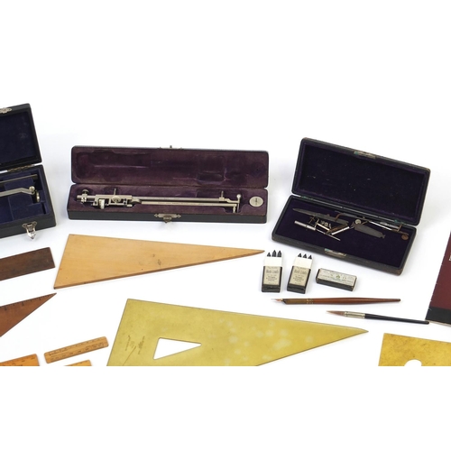 64 - Drawing instruments and rules including two cased planimeters, one by Stanley and three brass protra... 