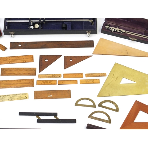 64 - Drawing instruments and rules including two cased planimeters, one by Stanley and three brass protra... 