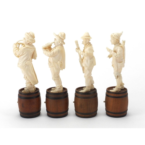 1 - Four 19th century Dieppe carved ivory musicians including a conductor, each standing upon ebonised w... 