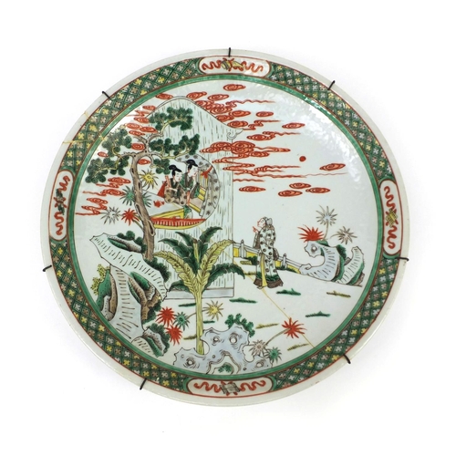 262 - Chinese porcelain charger, hand painted in the famille verte palette with figures in a palace settin... 