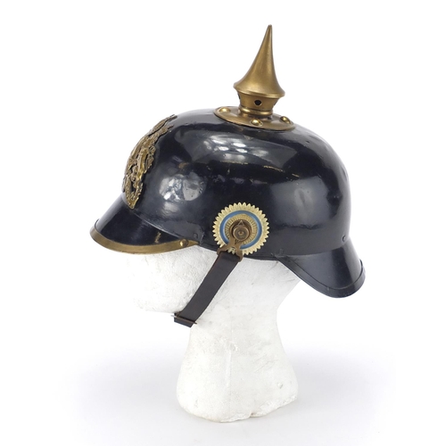 194 - German Military Pickelhaube with fitted case applied brass badge and chin strap, the pickelhaube 24c... 