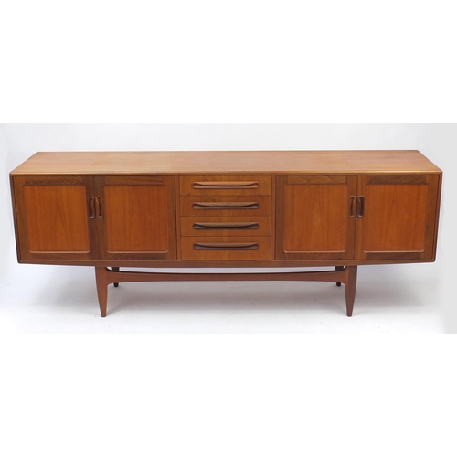 2026 - 1970's G-plan teak sideboard fitted four drawers flanked by two pairs of cupboard doors, label to th... 