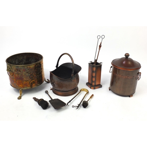 222 - Metal fire tools including brass coal bucket with lion mask handles and paw feet, copper coal bucket... 