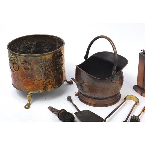 222 - Metal fire tools including brass coal bucket with lion mask handles and paw feet, copper coal bucket... 