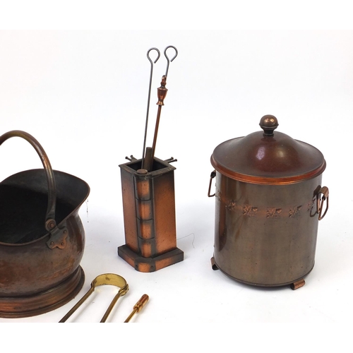 222 - Metal fire tools including brass coal bucket with lion mask handles and paw feet, copper coal bucket... 