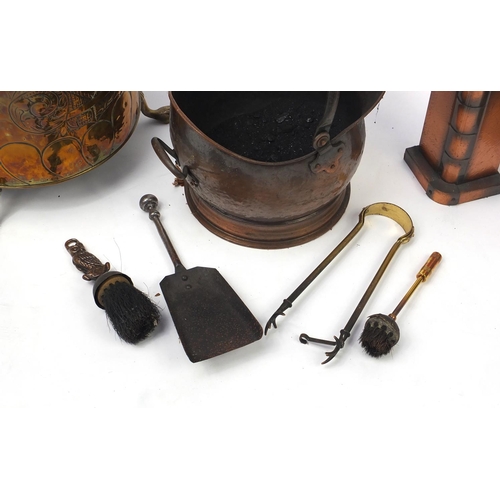 222 - Metal fire tools including brass coal bucket with lion mask handles and paw feet, copper coal bucket... 