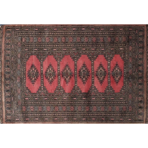 107 - Rectangular rug having all over geometric motifs onto a pink ground, 140cm x 95cm