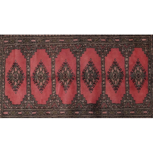 107 - Rectangular rug having all over geometric motifs onto a pink ground, 140cm x 95cm