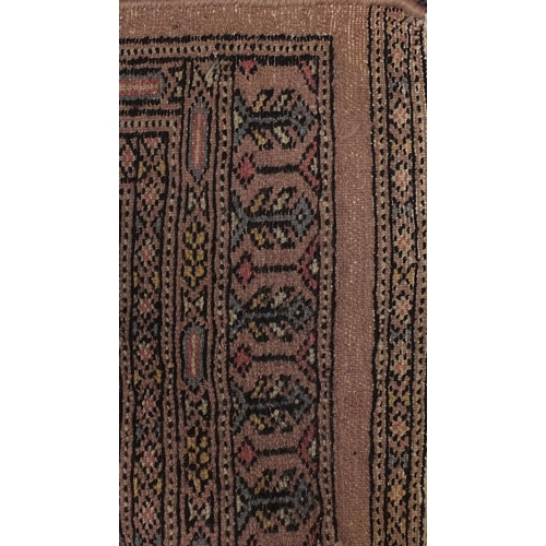 107 - Rectangular rug having all over geometric motifs onto a pink ground, 140cm x 95cm