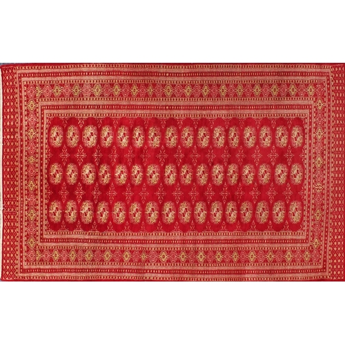 26 - Rectangular Persian rug having all over floral motifs onto a red ground, 190cm x 128cm