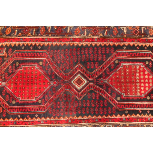 2054 - Rectangular Persian Kshan rug, having an all over floral and geometric design on to red dark ground,... 