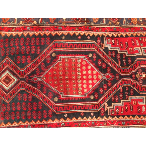 2054 - Rectangular Persian Kshan rug, having an all over floral and geometric design on to red dark ground,... 