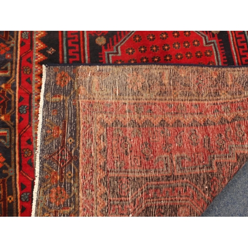 2054 - Rectangular Persian Kshan rug, having an all over floral and geometric design on to red dark ground,... 