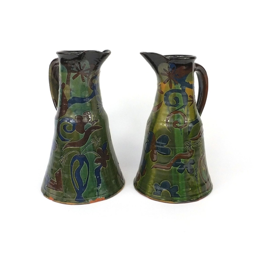 2248 - Pair of French art pottery ewers, incised and hand painted with floral motifs, the largest 29cm high