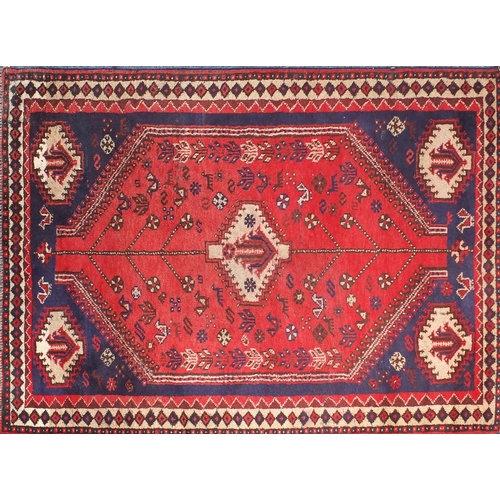 2080 - Rectangular persian rug having all over floral motifs onto a reg ground, approximately 225cm x 155cm