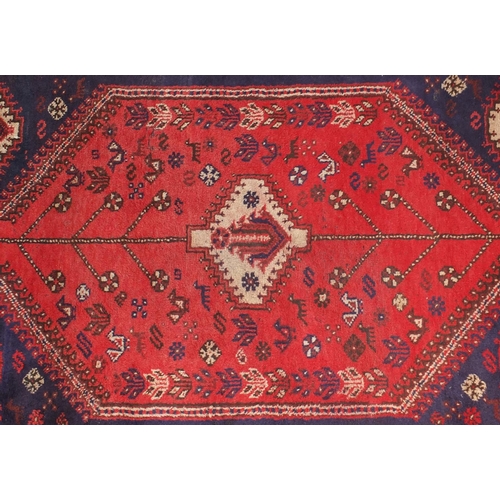 2080 - Rectangular persian rug having all over floral motifs onto a reg ground, approximately 225cm x 155cm