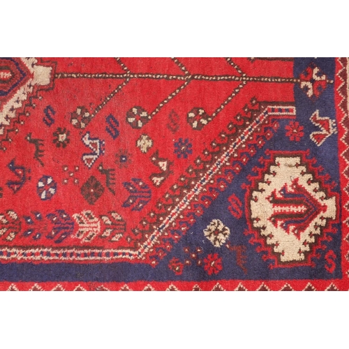 2080 - Rectangular persian rug having all over floral motifs onto a reg ground, approximately 225cm x 155cm