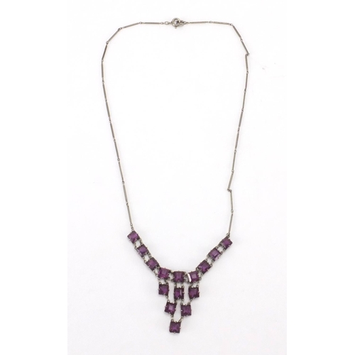 241 - Art Deco Platinon necklace set with purple glass stones, 36cm in length