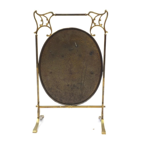 70 - Arts & Crafts brass fire screen, relief decorated with swags, 79cm high