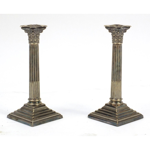 129 - Pair of silver plated Corinthian column candle sticks, 24cm high