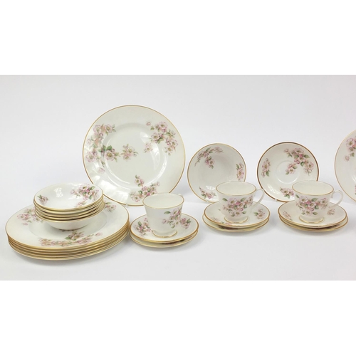 141 - Coalport dinner and teaware, including cups, saucers and dinner plates with floral decoration, each ... 