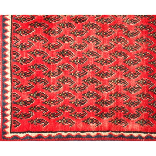 98 - Rectangular Persian hamadam carpet runner, having all over stylised design onto a red ground, 267cm ... 