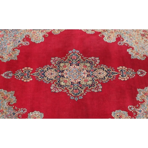 2014 - Large rectangular Kerman rug having an all over floral motifs, with corresponding boarders onto a re... 