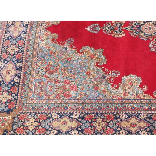 2014 - Large rectangular Kerman rug having an all over floral motifs, with corresponding boarders onto a re... 