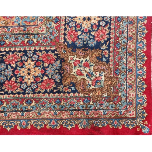 2014 - Large rectangular Kerman rug having an all over floral motifs, with corresponding boarders onto a re... 