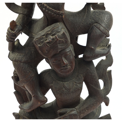 2097 - Large Middle Eastern carved wooden figure group of two figures, on a circular base, 77cm high