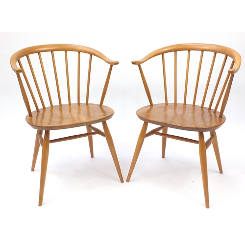 2050a - Pair of Ercol light elm stick back tub chairs, each with labels and 77cm high