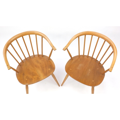 2050a - Pair of Ercol light elm stick back tub chairs, each with labels and 77cm high