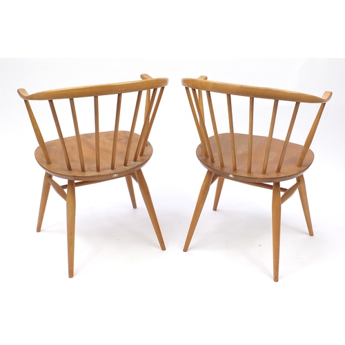 2050a - Pair of Ercol light elm stick back tub chairs, each with labels and 77cm high