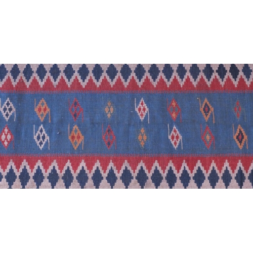 59 - Antique rectangular Kilim carpet runner, having a geometric design on to a blue ground, 280cm x 85cm