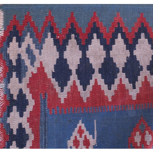 59 - Antique rectangular Kilim carpet runner, having a geometric design on to a blue ground, 280cm x 85cm
