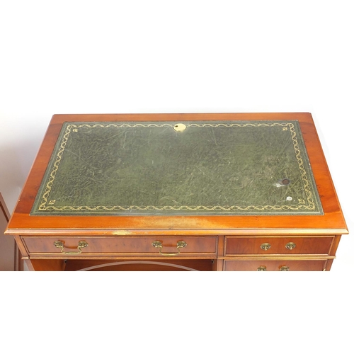 64 - Yew desk with tooled green leather insert and fitted with an arrangement of drawers, together with a... 