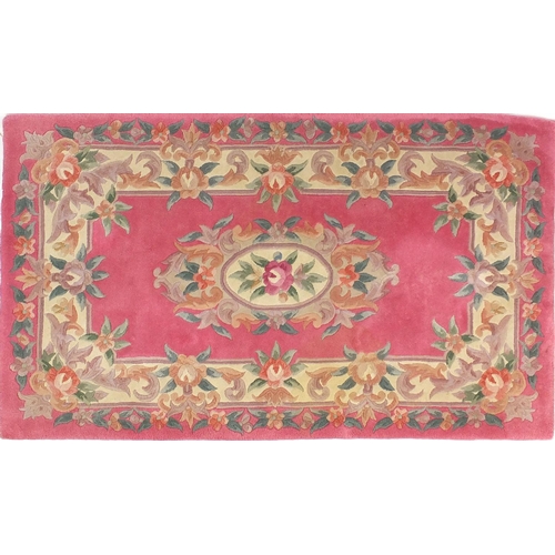 84 - Two pink ground floral rugs, each approximately 155cm x 90cm