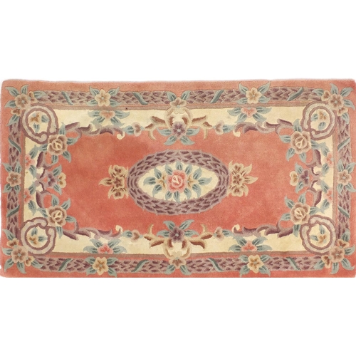 84 - Two pink ground floral rugs, each approximately 155cm x 90cm