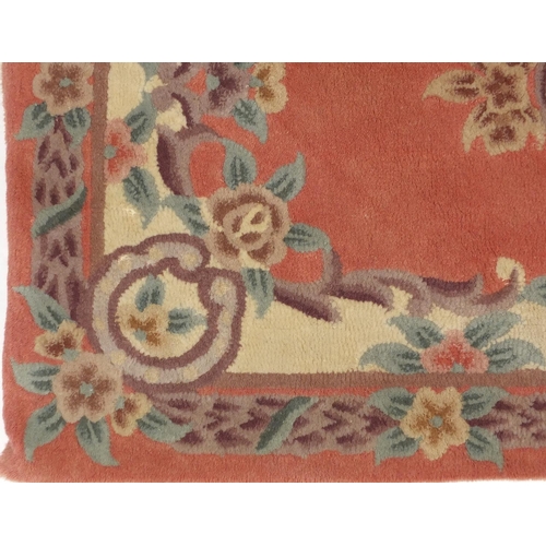 84 - Two pink ground floral rugs, each approximately 155cm x 90cm