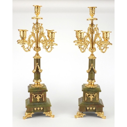 132 - Pair of onyx and gilt brass four branch candelabra, each 51cm high