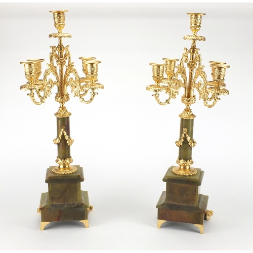 132 - Pair of onyx and gilt brass four branch candelabra, each 51cm high